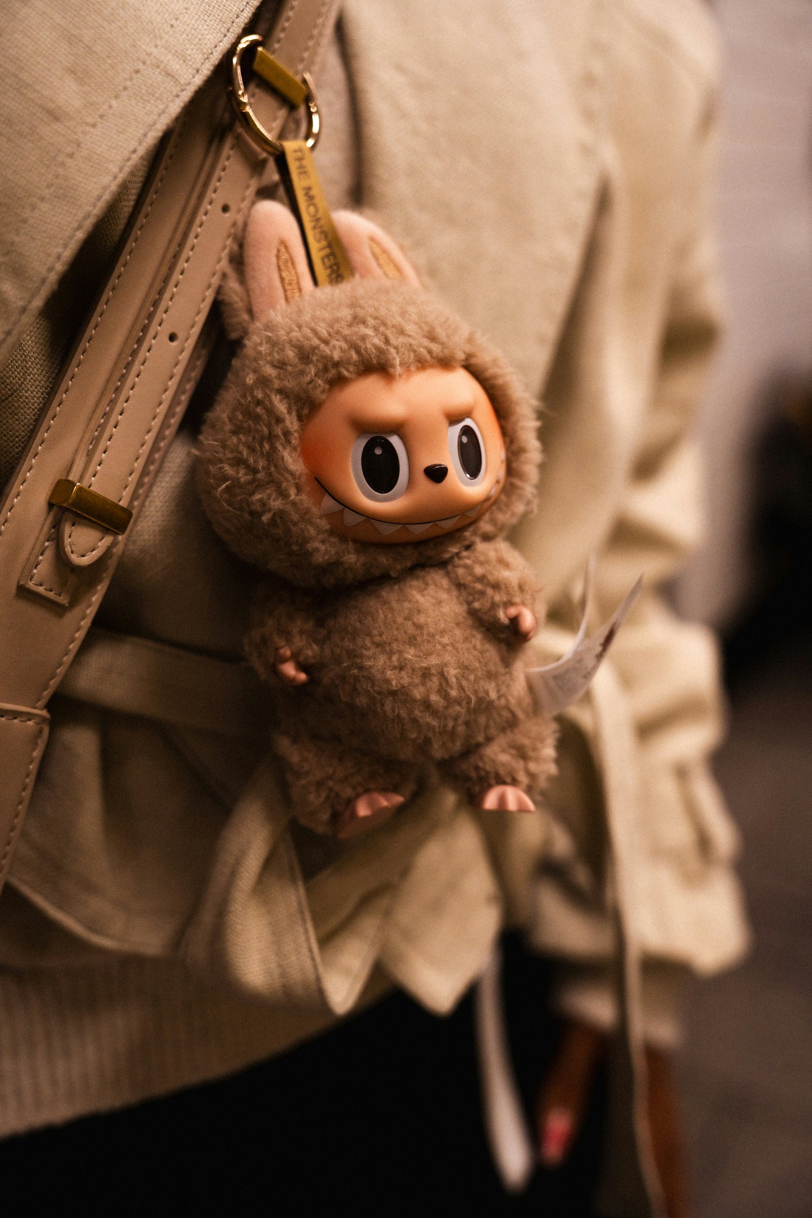 A real Labubu plush keychain hanging from a purse, demonstrating the authentic detailing collectors should expect.